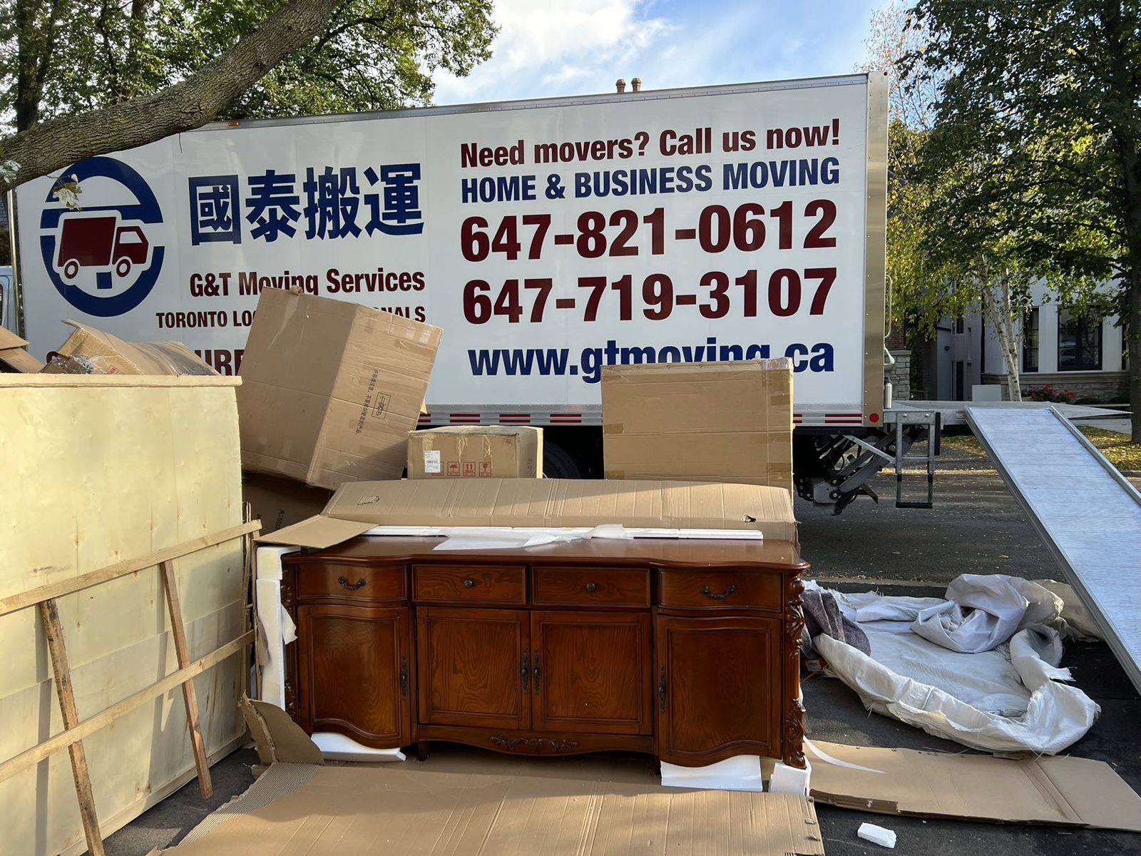 G&T Moving Services branded truck parked on a residential street during a house move
